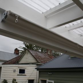 Under roof retractable shade